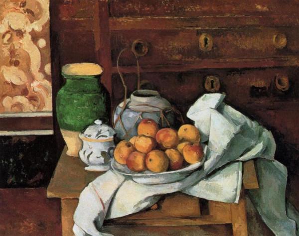 Vessels, Fruit And Cloth In Front Of A Chest by Paul Cezanne