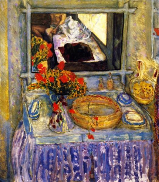 The Dressing Table With A Bunch Of Red And Yellow Flowers by Pierre Bonnard