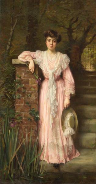 A Portrait Of A Lady In A Garden Wearing A Pink Dress Holding An Iris by Thomas Benjamin Kennington